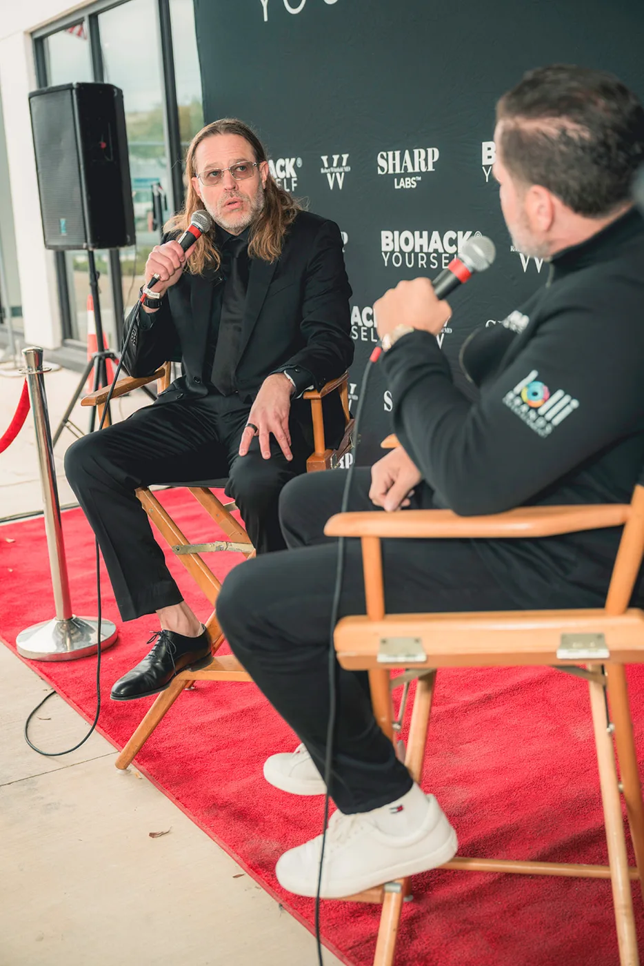 A red-carpet interview setup with director chairs at a client event