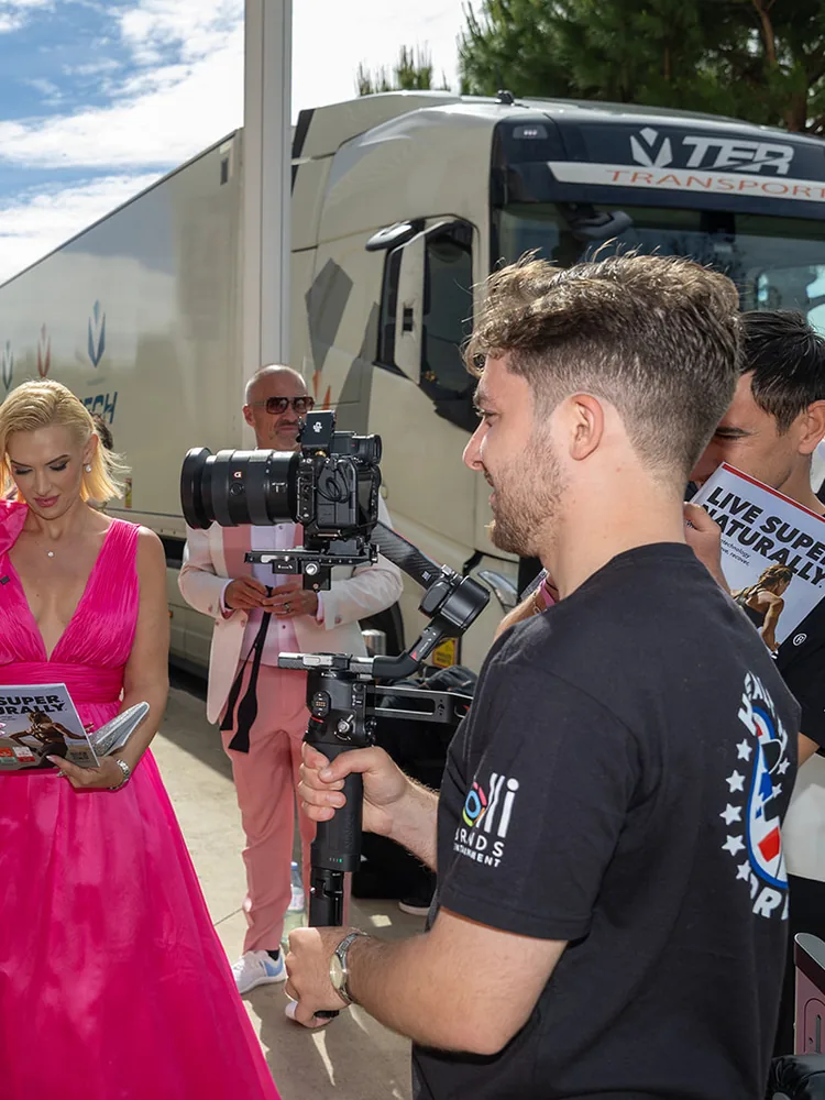 A Biohack Yourself videographer filming guests reading the issue, on location at Cannes
