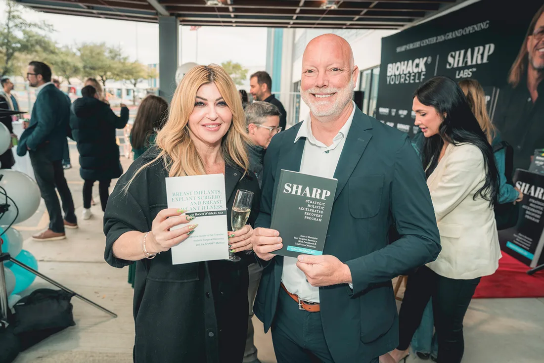 Guests holding Biohack Yourself pieces at a grand opening