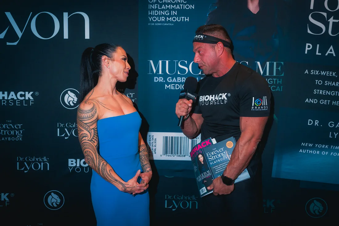 Dr. Gabrielle Lyon with a reader holding the magazine at her book signing